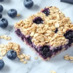Freshly baked blueberry oatmeal crumble bar with juicy berries